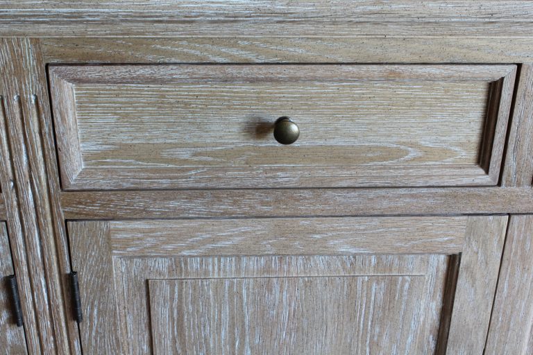The picture shows the draw with cupboard beneath showing the deatil of the limed oak finish highlighting the grain of the oak wood.