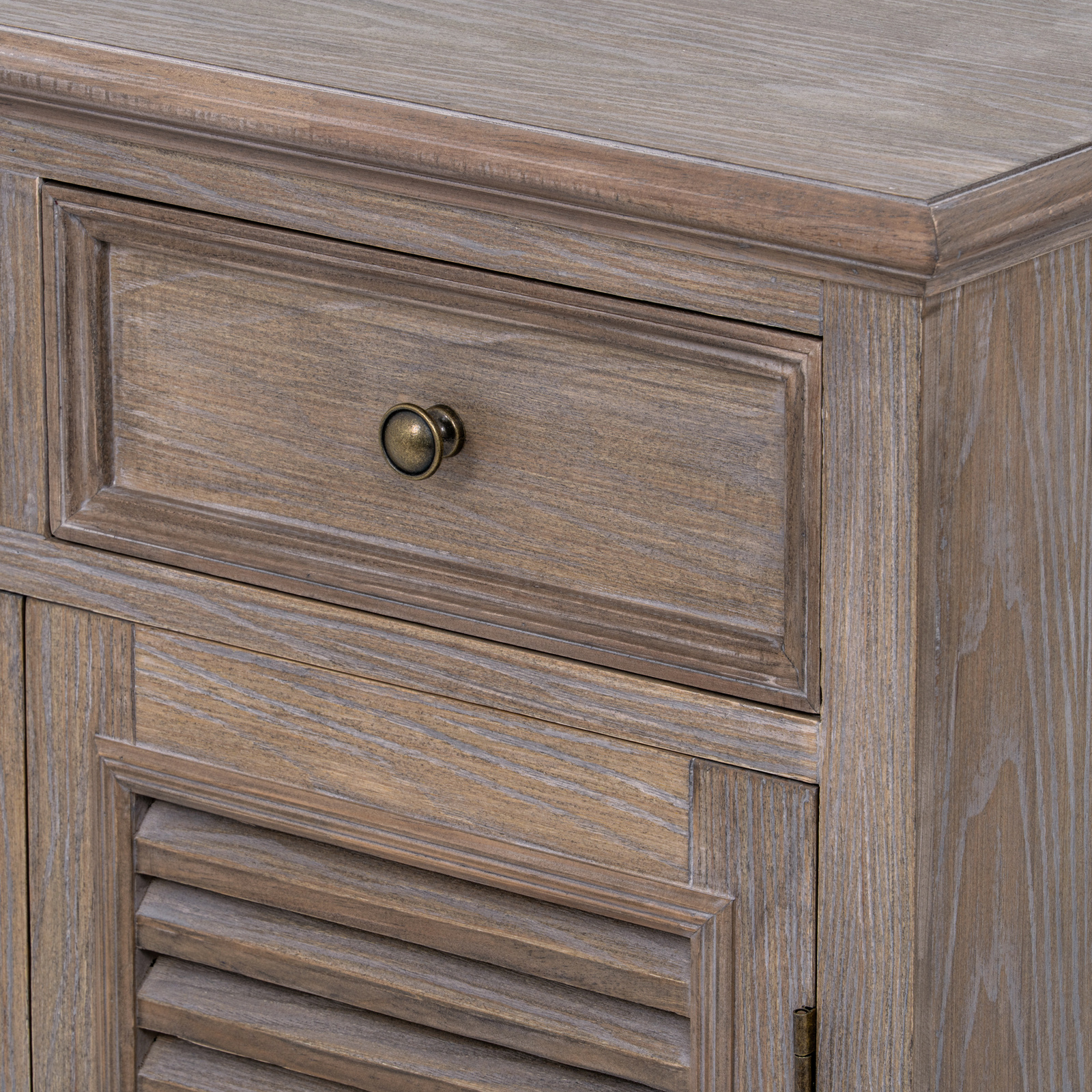 Image shows the detail of the door and drawer of a wooden storage cabinet